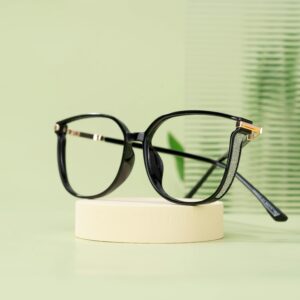 Home Modern black eyeglasses with a classic design resting on a minimalist display stand.